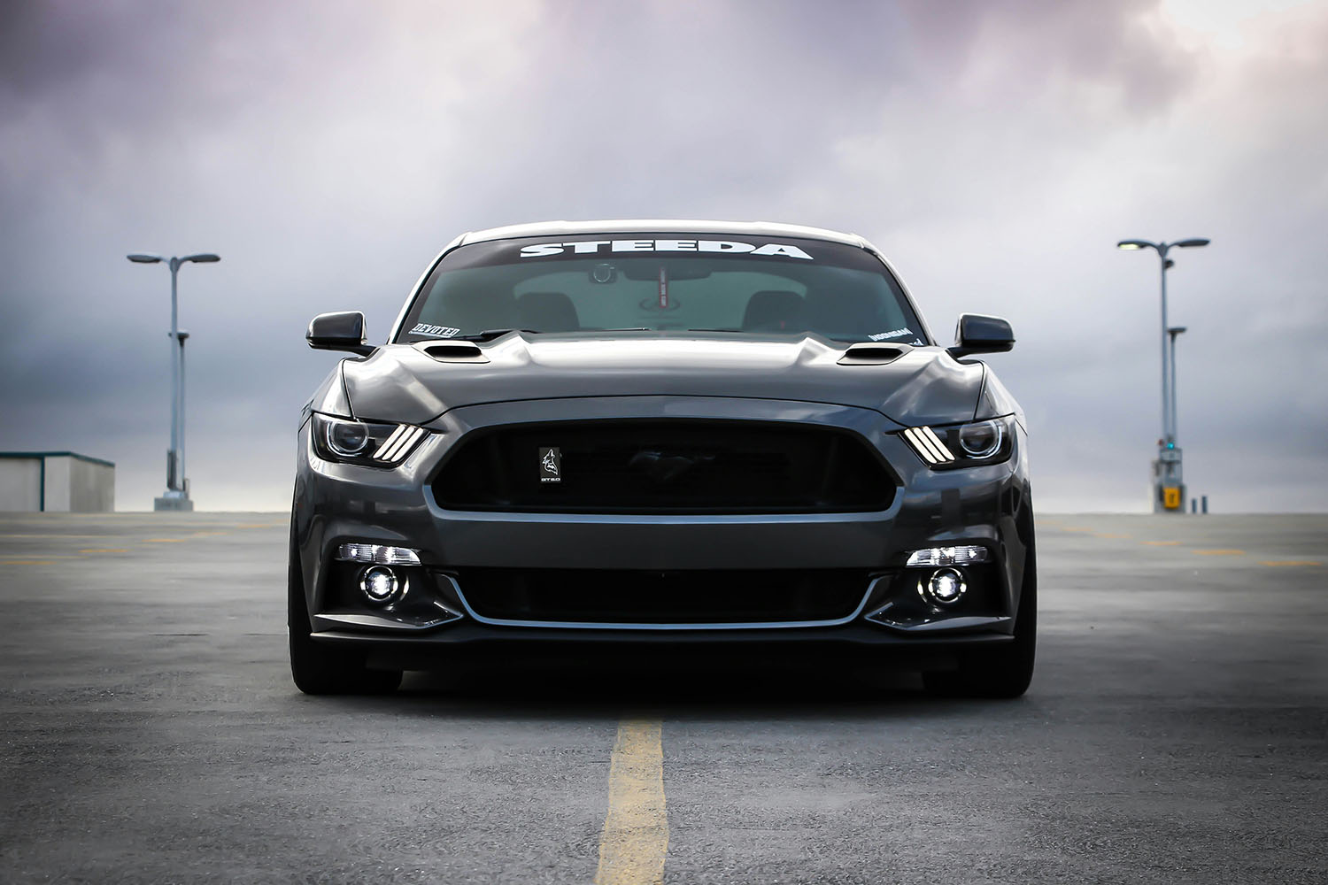 Front view of a dark gray Ford Mustang with 